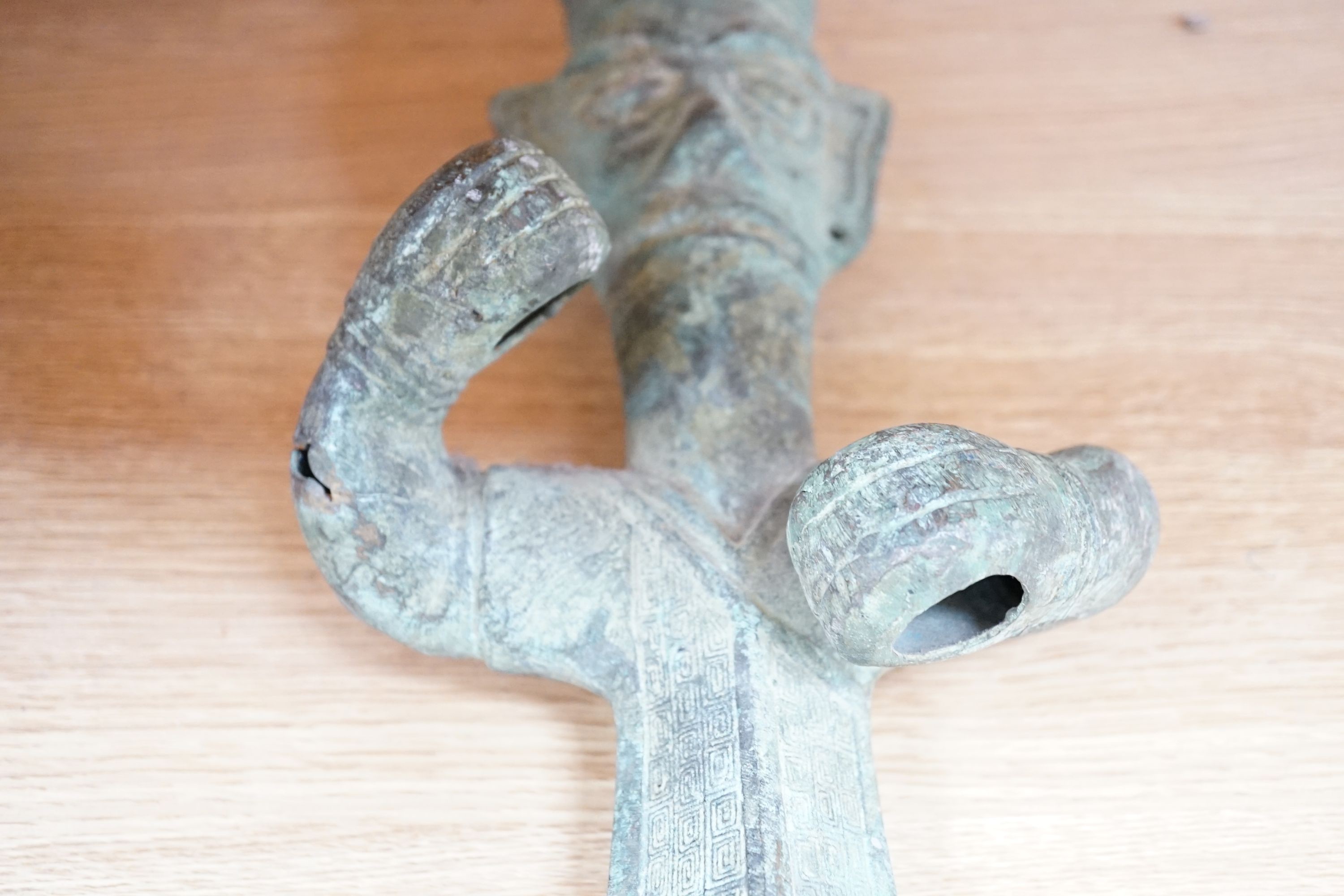 A large, archaic tic bronze figure, 76cm, and a bronze bell on chain